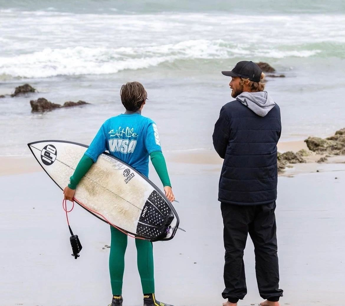 Coach talking with surfer before a heat