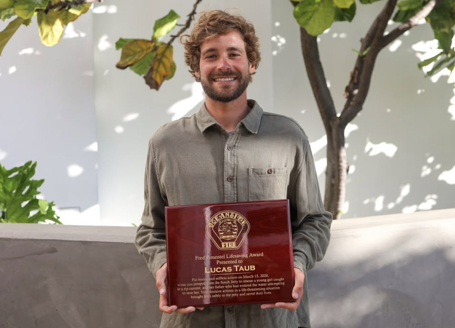 Lucas Taub holding the Oceanside Fire Fred Pimentel Lifesaving Award