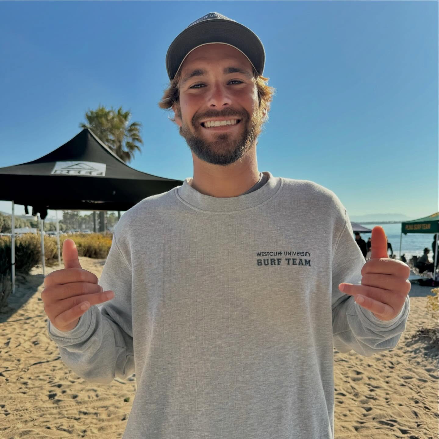 Lucas in a Westcliff University Surf Team sweatshirt