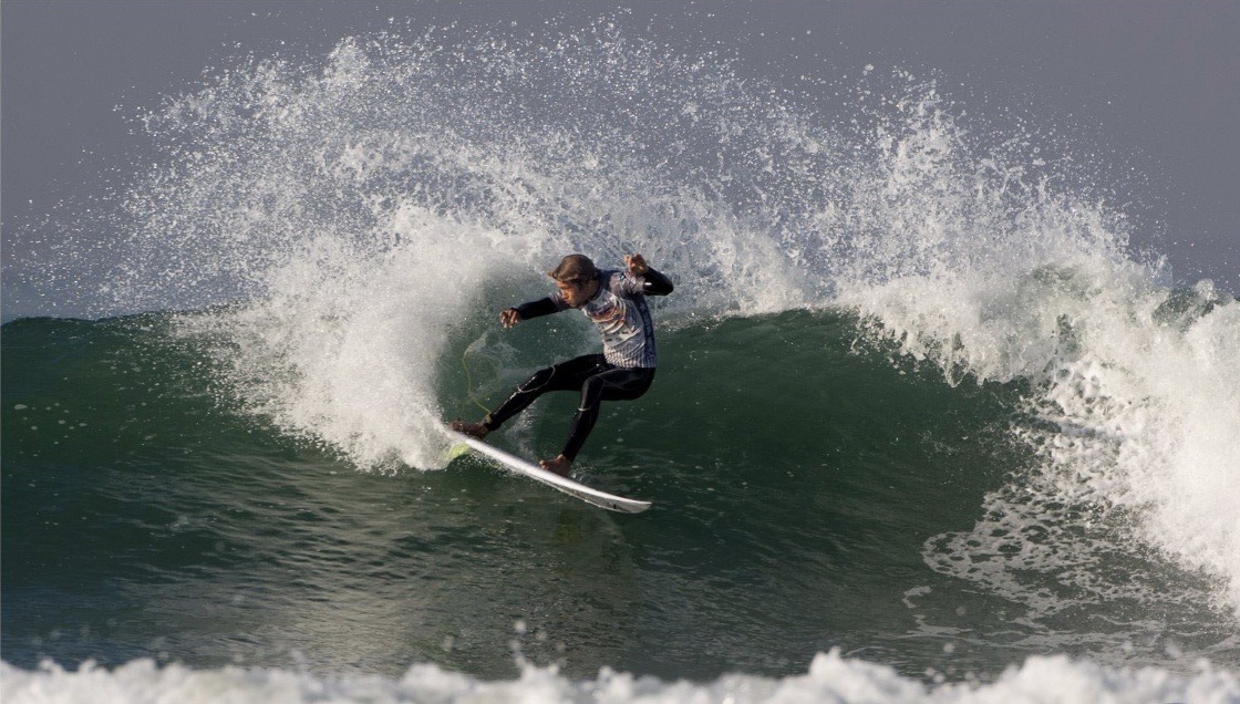 Young Lucas Taub carving hard and throwing a wall of spray