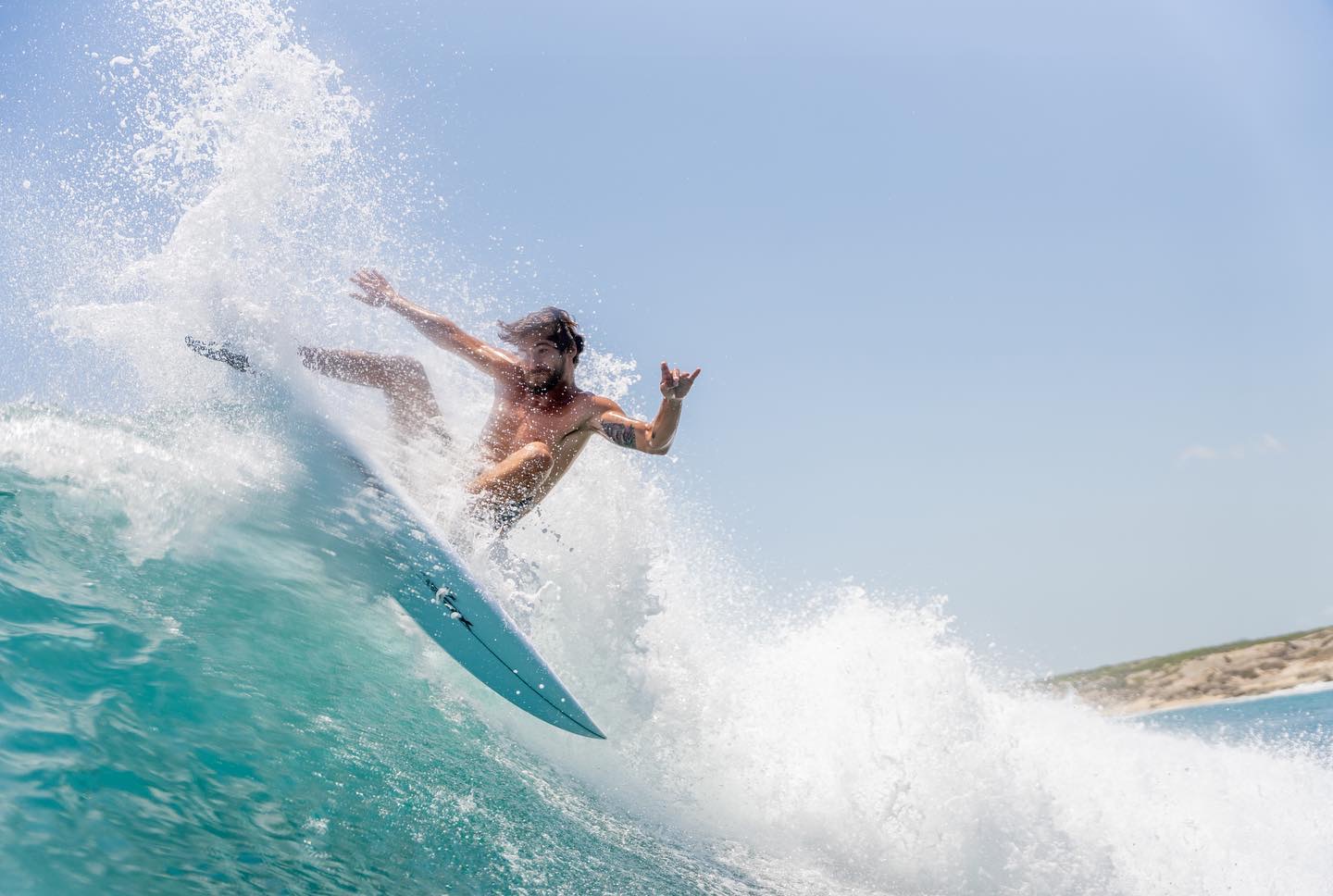 Surfer throwing spray on a turn