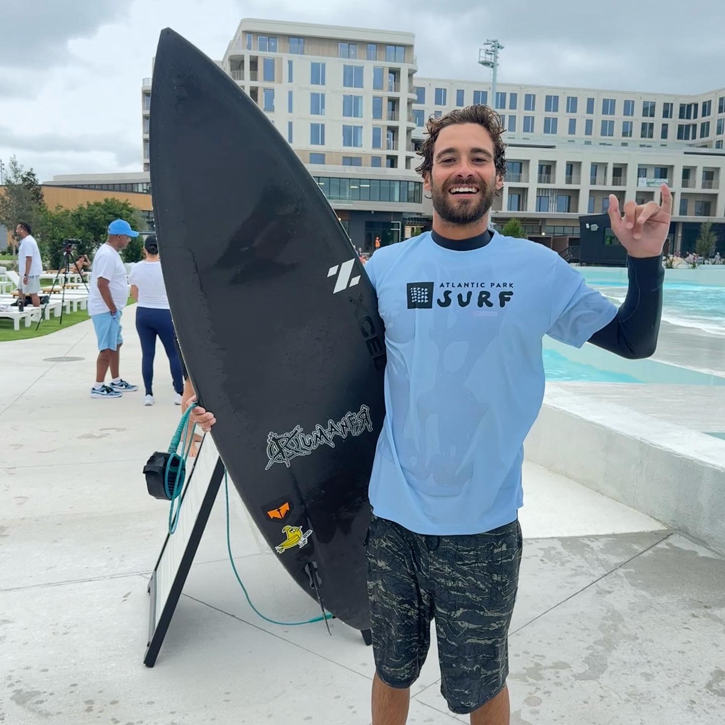 Surfer with his board at a wave pool